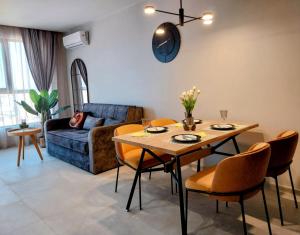 a living room with a table and a couch at Ika Delux in Burgas