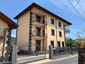 a building with a fence in front of it at La Maison Du Soleil Rooms in Agerola