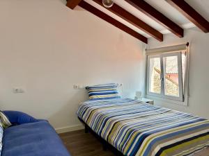 a bedroom with a bed and a window at Carmen Luxury House in Muros