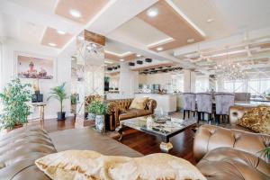 a living room with couches and a table at Roof Top Villa Budva in Budva