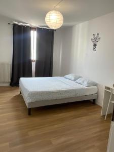 a bedroom with a bed and a black curtain at Le Repaire Urbain - 8 voyageurs in Orléans