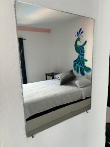 a mirror reflection of a bed in a bedroom at test hotel in Guadalajara