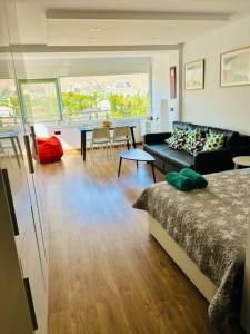 a living room with a bed and a couch and a table at TrendyHomes Aguadulce Bay II in Aguadulce
