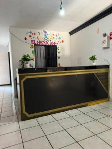 a reception desk in a room with a sign on the wall at test hotel in Guadalajara