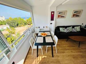 a small living room with a table and a balcony at TrendyHomes Aguadulce Bay II in Aguadulce