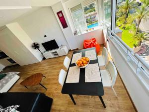 a living room with a table with a bowl of oranges on it at TrendyHomes Aguadulce Bay II in Aguadulce +11 photos