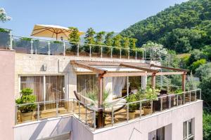 a balcony with potted plants on a building at Roof Top Villa Budva in Budva