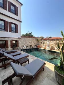 a villa with a swimming pool and patio furniture at Villa Ephesus Hotel in Kuşadası