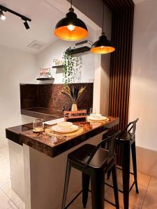 a kitchen with a table with two chairs and two lights at The Lounge Platinum by KRD in Butuan