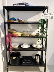a black shelf with plates and dishes on it at The Lounge Platinum by KRD in Butuan +4 photos