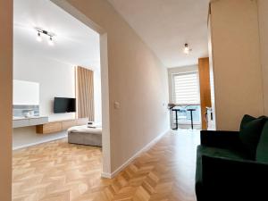 a living room with a couch and a television in a room at Airport Nest Private Parking, AC and Smart TV in Cluj-Napoca