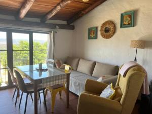 a living room with a couch and a table at Cercado de arriba in Cortelazor