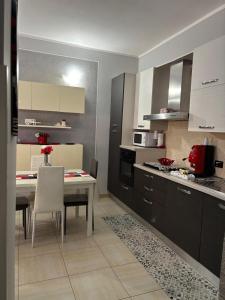 a kitchen with a table and a dining room at AltaMil Home in Altavilla Milicia
