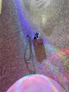 a tiled bathroom with a shower with a hose at Appartamento vacanze Rotonda Sunrise in Senigallia +38 photos