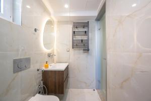 a white bathroom with a toilet and a sink at Diamante Del Mar Thalia and Erato in Kos +40 photos