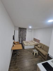 a living room with a couch and a bed at Summer Apartments in Shengjin in Shëngjin