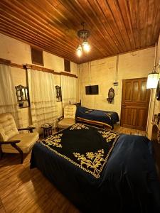a bedroom with two beds and a couch and a tv at aynur hanım konağı butik otel in Şahinbey