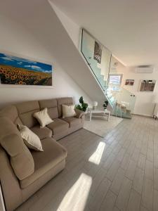 a living room with a couch and a staircase at Magnolia in Francavilla al Mare