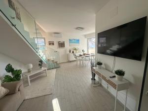 a living room with a large flat screen tv on a wall at Magnolia in Francavilla al Mare