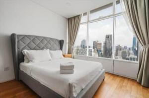 a bedroom with a large bed with a large window at Vortex KLCC by Family Suites in Kuala Lumpur +115 photos