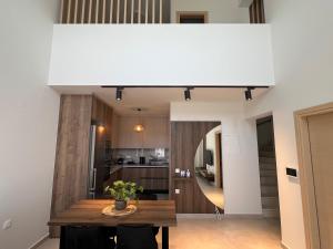 ネア・ムダニアにあるHasi Suites Two Bedroom Duplexのキッチン、ダイニングルーム(テーブル付)