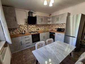 a small kitchen with a table and a refrigerator at Yerevan Nar-Dos in Yerevan