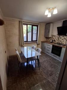 a kitchen with a dining room table and chairs at Yerevan Nar-Dos in Yerevan +5 photos