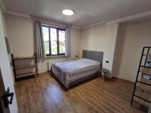 a bedroom with a bed and a window at Yerevan Nar-Dos in Yerevan