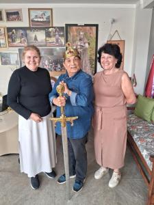 a group of three women standing in a room with a cross at Pousada Castelo do Rei in Penha