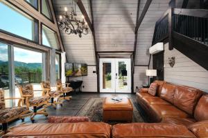 a living room with a brown leather couch and chairs at Amazing Grace Where Peace Finds You in Pigeon Forge