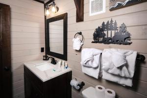 a bathroom with a sink and a mirror at Amazing Grace Where Peace Finds You in Pigeon Forge +48 photos