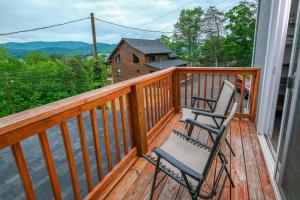 a rocking chair on a deck with a view at Amazing Grace Where Peace Finds You in Pigeon Forge