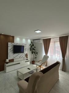 a living room with a couch and a tv at Villa Elena in Ohrid