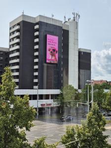 a large building with a large pink sign on it at Apartment No 3 in Braunschweig
