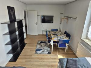 a dining room with a table and blue chairs at Apartment No 3 in Braunschweig