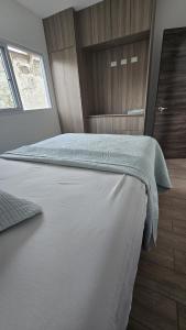 a bedroom with a large white bed and a window at Relaxation House  +4 photos