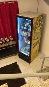 an open refrigerator with a box next to it at Casa Hotel Formosa 41 in São Leopoldo