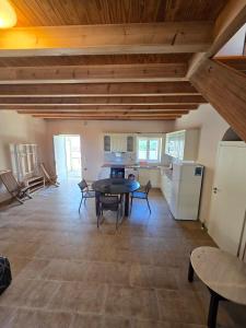 a large living room with a table and a kitchen at Villa Castel in Himare