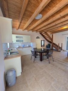 a kitchen with a table and chairs in a room at Villa Castel in Himare