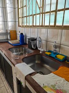 a kitchen with a sink and a counter top at Residencial Samara in Rondonópolis