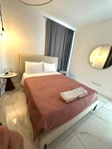 a bedroom with a bed with two towels on it at City Lights - Luxury Penthouse - Panoramic view - Near Unic in Nicosia