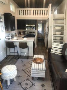 a living room with a couch and a kitchen at Still Waters Tiny Home in Tracy City +60 photos