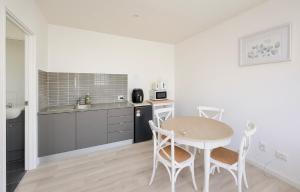 a kitchen with a table and chairs in a room at Private guest house Gold Coast - sleeps max 4 in Gold Coast