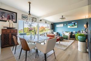 a dining room and living room with a table and chairs at Luxury Vacation House with Breathtaking Soundview in Federal Way