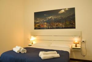 莱科Pizza & Pizzoccheri House的一间卧室，床上有一张带毛巾的床