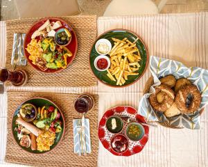 a table with four plates of food on it at Sea Salt Inn , Kitchene in Kemer