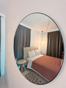 a bedroom with a bed and a round mirror at Luxury City Penthouse-Panoramic View-Near Unic in Nicosia