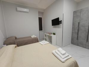 a bedroom with a bed with two towels on it at Le follie in Maddaloni +72 photos