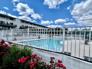 a balcony with a swimming pool in a building at Renovated OC Condo Walk to Beach Pool & Park in Ocean City