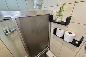 a bathroom with a toilet with two rolls of toilet paper at Condomínio Summer Park Bloco G in Brasilia +33 photos